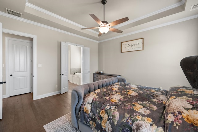 bedroom with crown molding, ceiling fan, a tray ceiling, and dark wood-type flooring