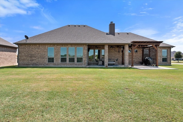 rear view of property featuring a patio area and a lawn