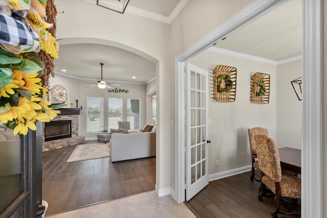 interior space with ornamental molding and light tile patterned floors