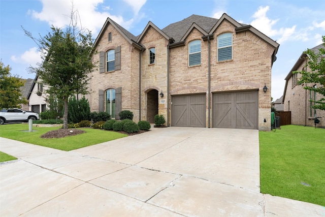 view of front of home with a front yard and a garage