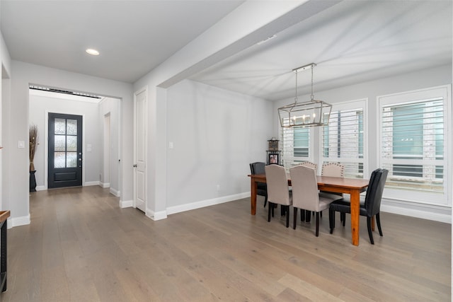 dining room featuring wood-type flooring and a chandelier