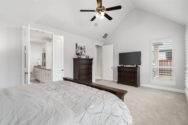 carpeted bedroom with ensuite bath, high vaulted ceiling, and ceiling fan