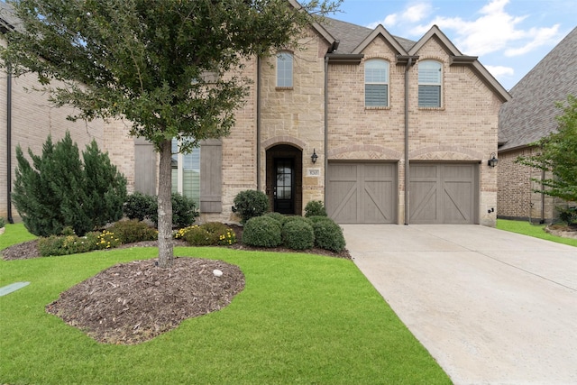 view of front of home featuring a front yard and a garage