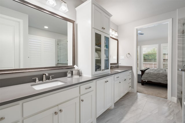 bathroom with walk in shower and vanity