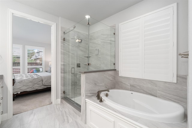 bathroom featuring separate shower and tub