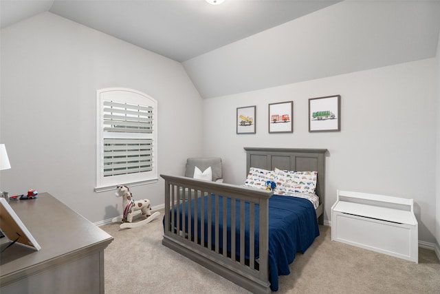 carpeted bedroom featuring lofted ceiling