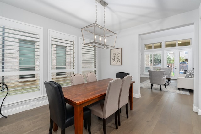 dining space with a notable chandelier, dark hardwood / wood-style floors, and french doors