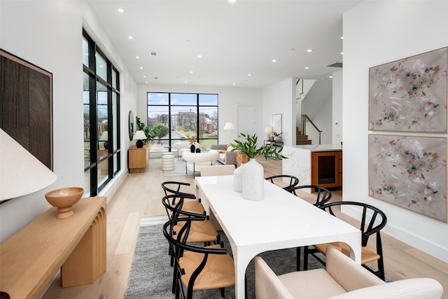 dining room featuring stairway, light wood-style flooring, visible vents, and recessed lighting