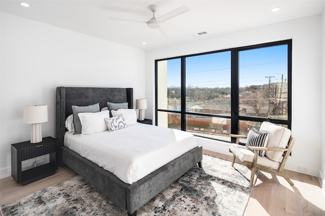 bedroom with ceiling fan and light hardwood / wood-style floors