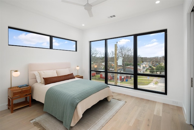 bedroom featuring recessed lighting, visible vents, light wood-style flooring, a ceiling fan, and baseboards