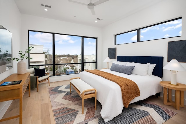 bedroom featuring light wood-type flooring, visible vents, and recessed lighting