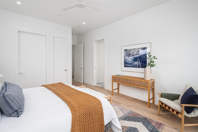 bedroom with light wood finished floors, baseboards, a ceiling fan, and recessed lighting