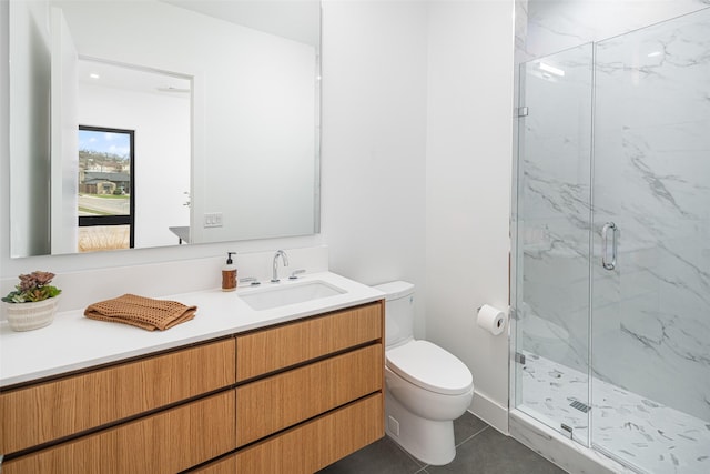 full bathroom featuring a marble finish shower, vanity, toilet, and tile patterned floors