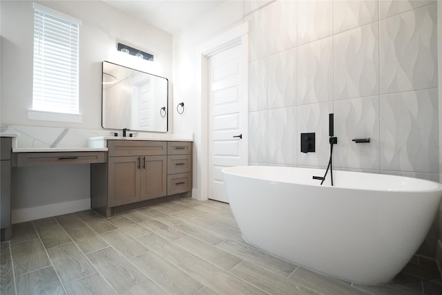 bathroom featuring wood-type flooring, vanity, tile walls, and a tub