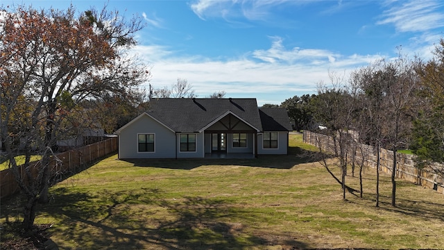 view of front of home with a front yard and a patio