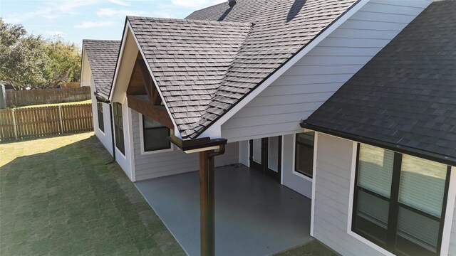 view of side of home featuring a patio area and a yard