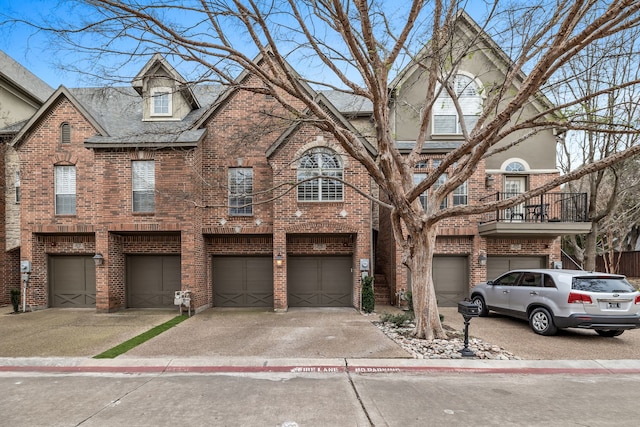 4141 Towne Green Cir, Addison, TX 75001 - view of property featuring driveway, a garage, and brick siding