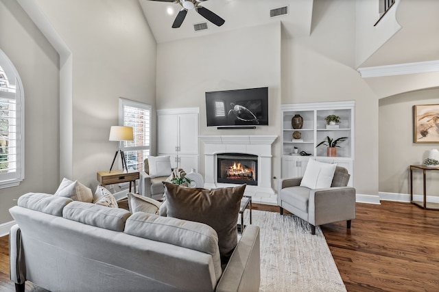 4141 Towne Green Cir, Addison, TX 75001 - living room with high vaulted ceiling, a lit fireplace, ceiling fan, dark wood-type flooring, and baseboards