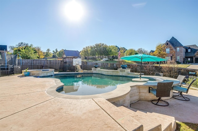 view of swimming pool with a patio area and an in ground hot tub