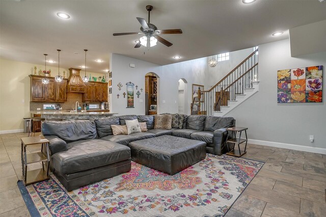 living room featuring ceiling fan and sink