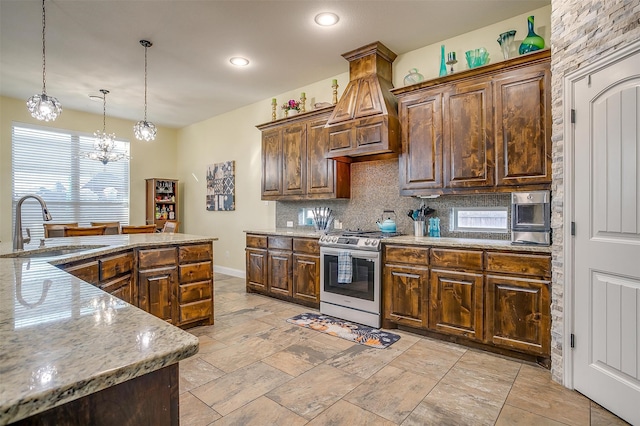 kitchen with sink, tasteful backsplash, stainless steel range oven, a chandelier, and decorative light fixtures