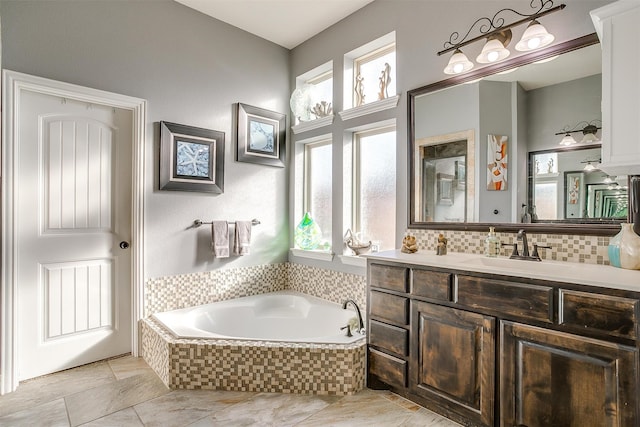 bathroom with tiled bath and vanity