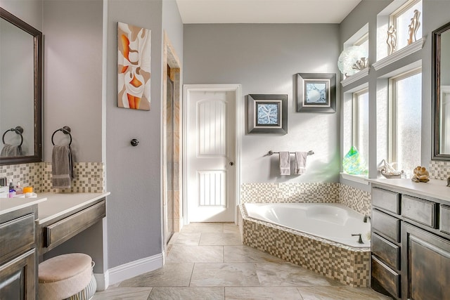 bathroom featuring vanity and tiled tub