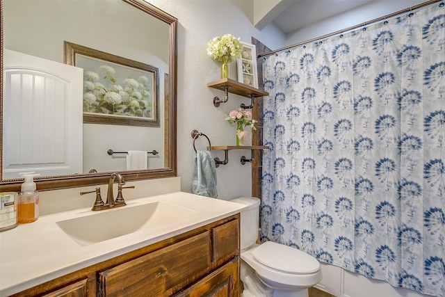 bathroom with vanity, a shower with shower curtain, and toilet