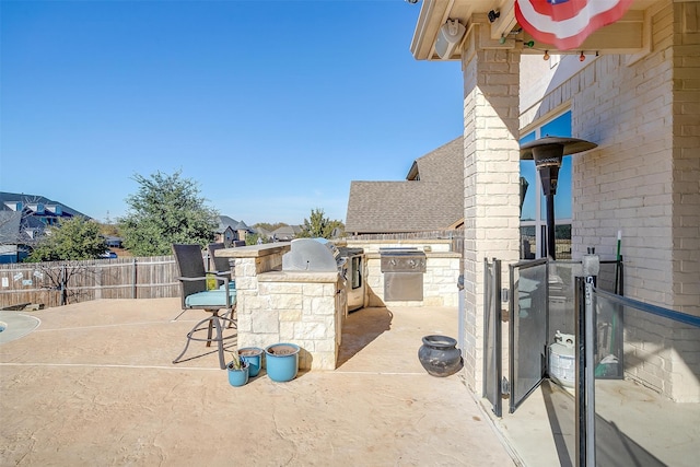 view of patio / terrace with a grill, exterior kitchen, and exterior bar