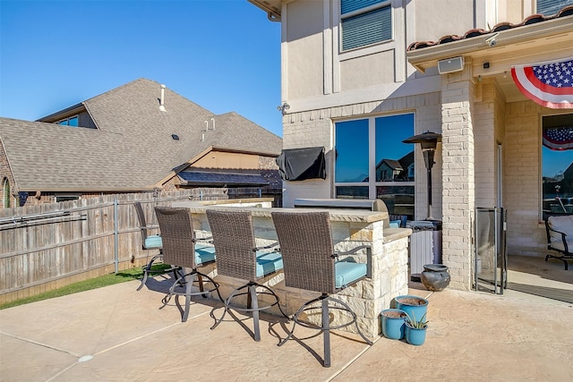 view of patio featuring an outdoor bar