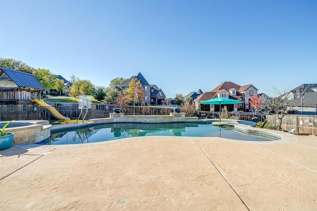 view of swimming pool featuring a playground and a patio