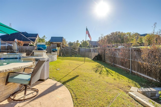 view of yard featuring a trampoline and a playground