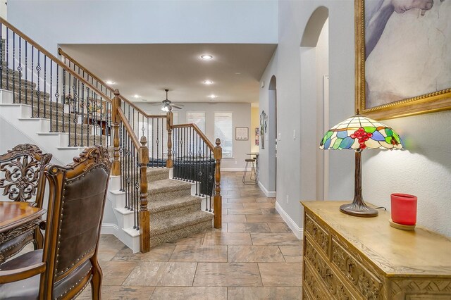 foyer entrance featuring ceiling fan