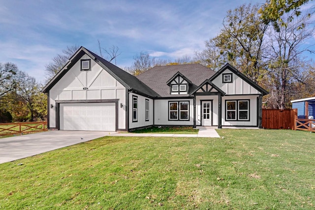 tudor home featuring a front yard and a garage