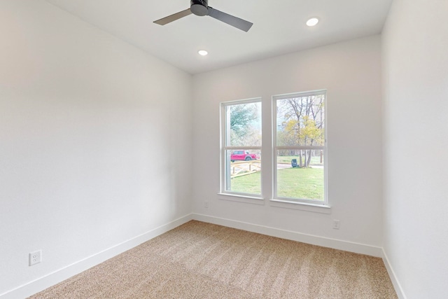 empty room with ceiling fan and carpet