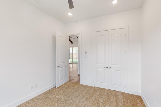 unfurnished bedroom with carpet floors, ceiling fan, and a closet