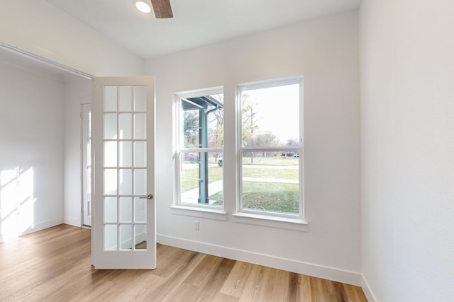 empty room featuring ceiling fan, plenty of natural light, and light hardwood / wood-style flooring