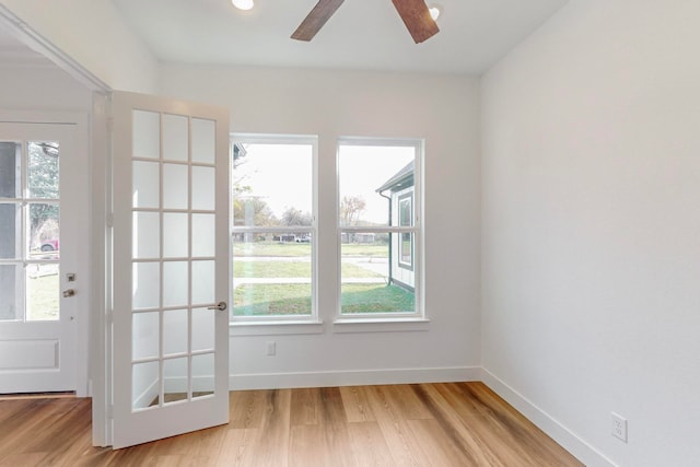 doorway to outside featuring ceiling fan, a healthy amount of sunlight, and light hardwood / wood-style floors