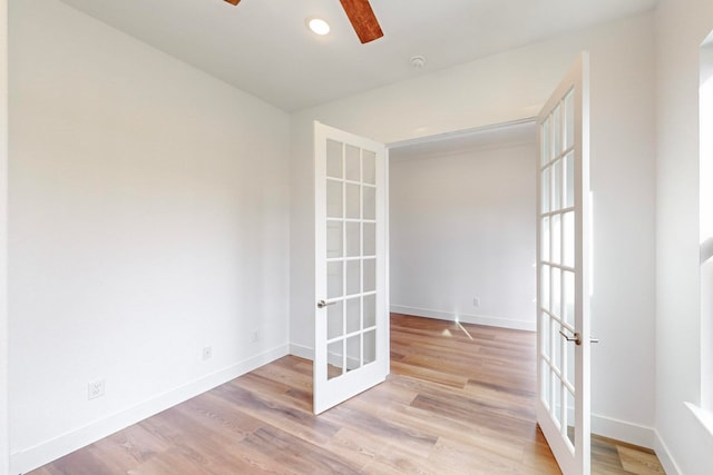 empty room featuring light hardwood / wood-style flooring, french doors, and ceiling fan