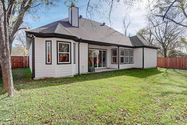 back of house featuring a lawn