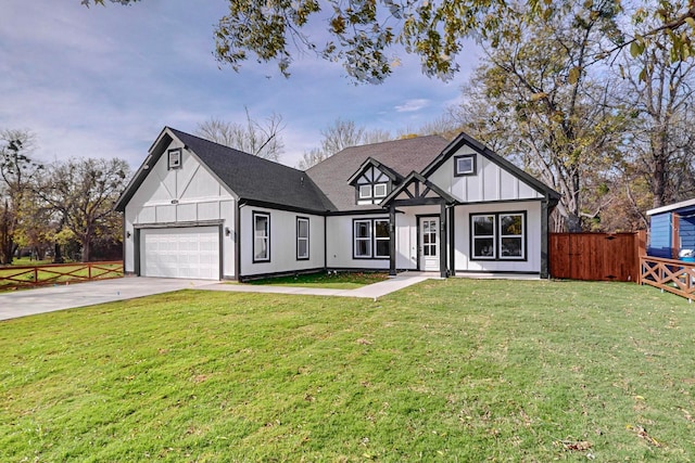 tudor house featuring a garage and a front yard