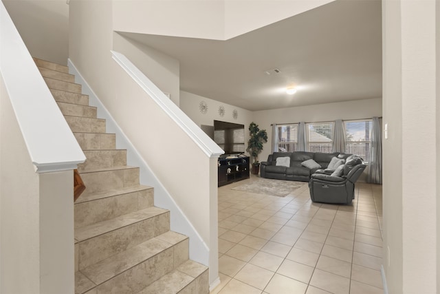 staircase featuring tile patterned floors