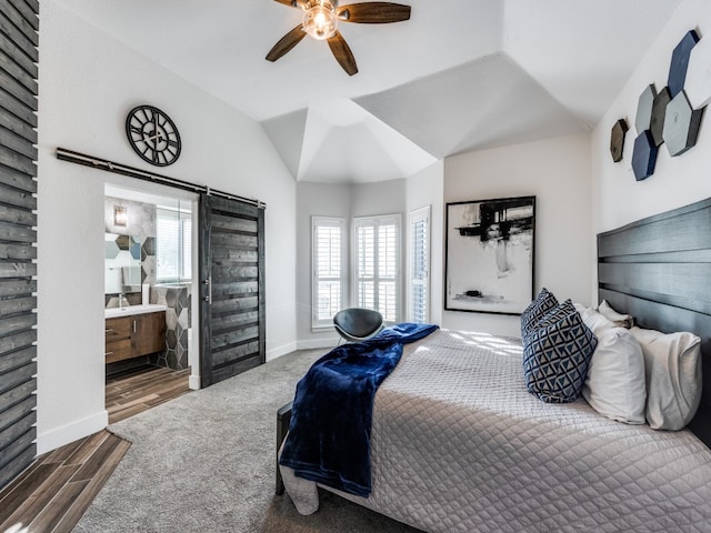 bedroom with hardwood / wood-style flooring, ceiling fan, lofted ceiling, and ensuite bathroom