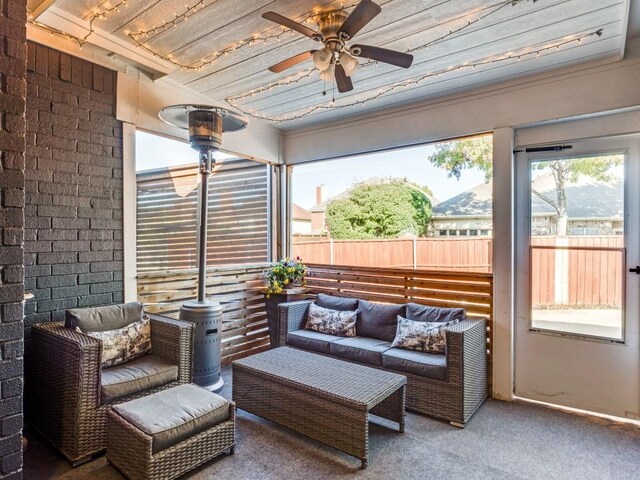 sunroom featuring ceiling fan and wood ceiling