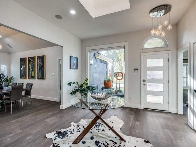 entryway featuring ceiling fan, wood-type flooring, and a skylight