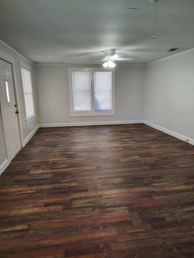 empty room featuring ornamental molding, dark hardwood / wood-style floors, and ceiling fan