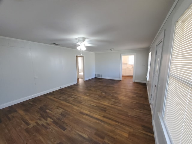 spare room with crown molding, dark hardwood / wood-style floors, and ceiling fan