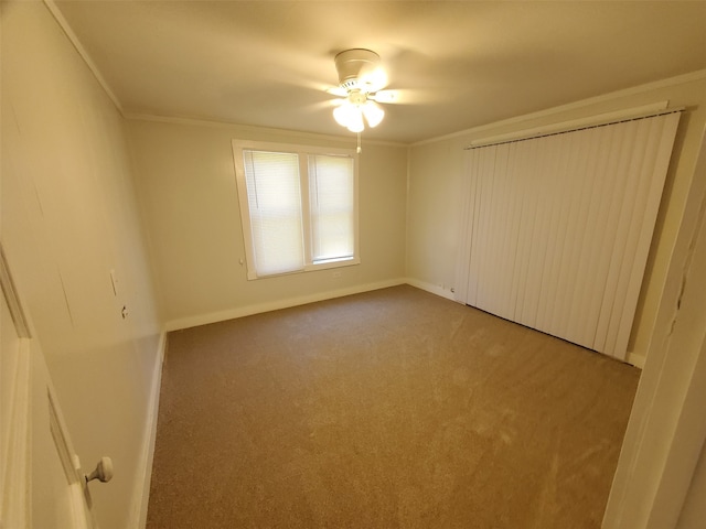 unfurnished bedroom featuring crown molding, ceiling fan, and carpet flooring