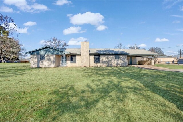 single story home featuring a front yard and a carport