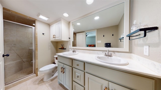 bathroom with tile patterned flooring, toilet, walk in shower, and vanity